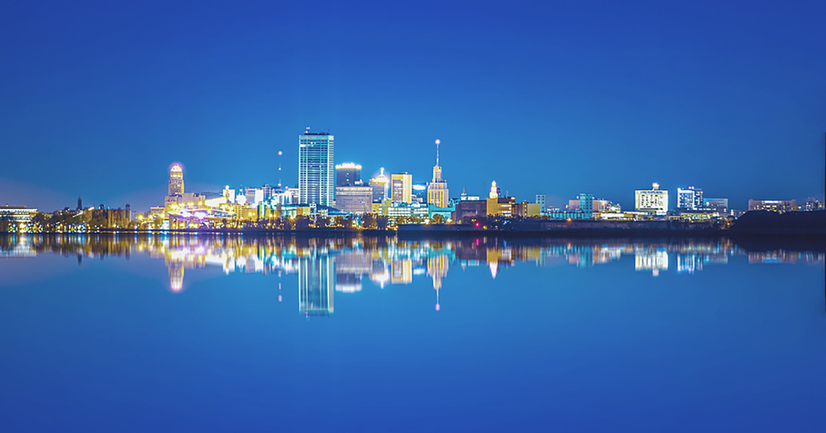 Tour Page buffalo lit up by water